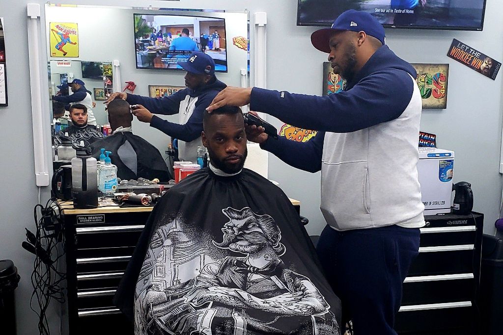 Damon cutting client hair